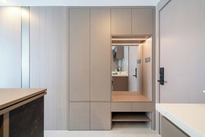A modern, minimalist bathroom with a walk-in shower, a mirror, and a toilet. - Modern 2BR Apt near Bangtao Beach - Pool - Gym & WiFi (Choeng Thale)