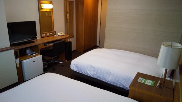 A hotel room with two beds, a desk with a computer, a telephone, and a small refrigerator. - Hotel Route-inn Odate (Odate)