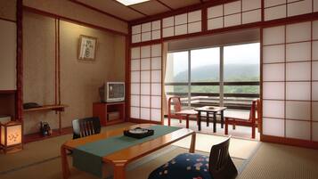 A traditional Japanese room with tatami flooring, a low table, chairs, a television, and a large window offering a view of greenery.