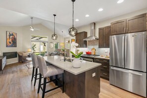 A modern kitchen with a large island, stainless steel appliances, and dark wooden cabinets. - Newer Animas Valley Home, Pet Friendly, A/C, Single Level, Red Cliff Views (Durango)