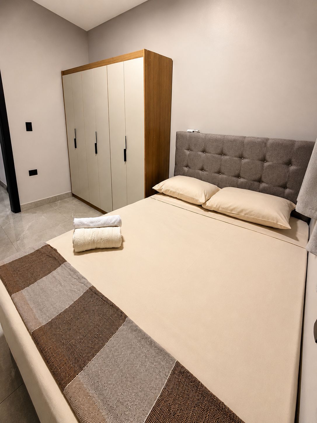 Ein Schlafzimmer mit einem Bett, einem Kleiderschrank und einer Kopfteil.