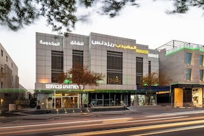 A multi-story hotel with a modern facade, featuring large windows and a prominent signage for 'MUHAIDB SIDENCE'. - Al Muahidb Residence Al Takhasossi 4 (Riyadh)