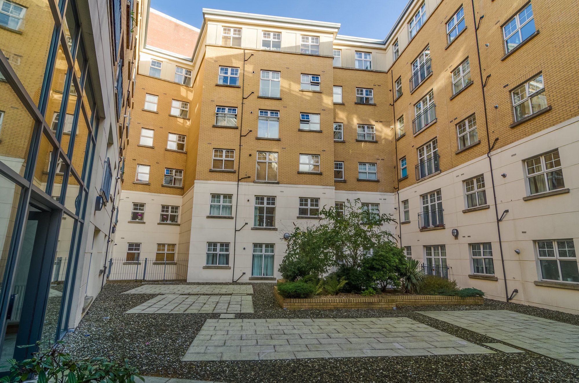 A multi-story residential building with a courtyard.