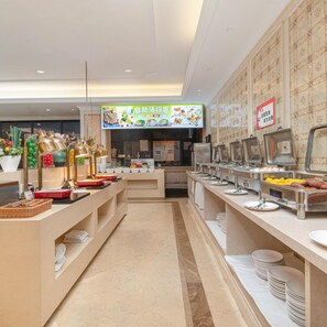 A buffet setup with multiple food stations, a menu board, and a clean, modern interior. - Vienna Hotel Shenzhen (Shenzhen)