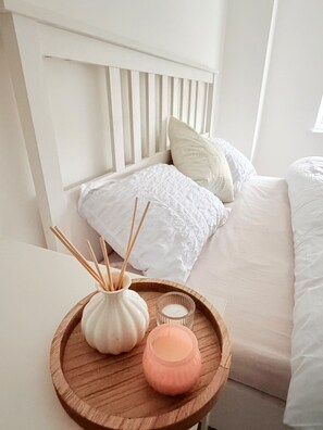 A neatly made bed with white bedding and a wooden headboard. - M C R SkyLine View 2-Br Apartment w/ Free Parking (Salford)