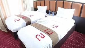 A hotel room with two beds, a brown headboard, and a red carpet. - Dib Anbessa Hotel (Bahir Dar)