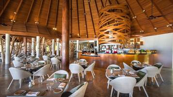 A spacious indoor dining area with high ceilings and natural light.