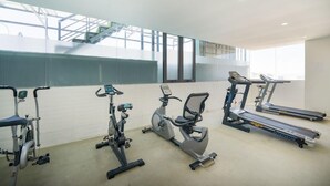 A gym with various exercise equipment including treadmills, an elliptical, and a stationary bike. - Gemma Hotel (Da Nang Municipality)