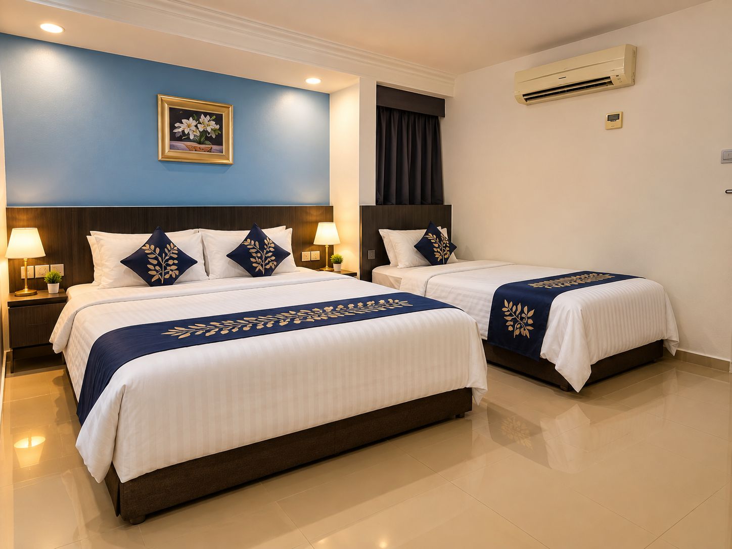 A hotel room with two beds, a nightstand with lamps, a wall-mounted air conditioner, and a framed picture on the wall.