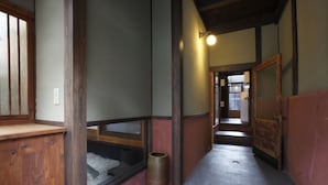 A narrow hallway with wooden walls and a tiled floor. - Shimoza-an (Kyoto)
