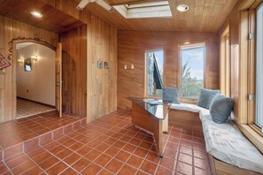 A wooden interior with a glass table, a bench, and a view through a window. - Cozy 3-bedroom bed & breakfast in charming Jefferson with AC (Jefferson)