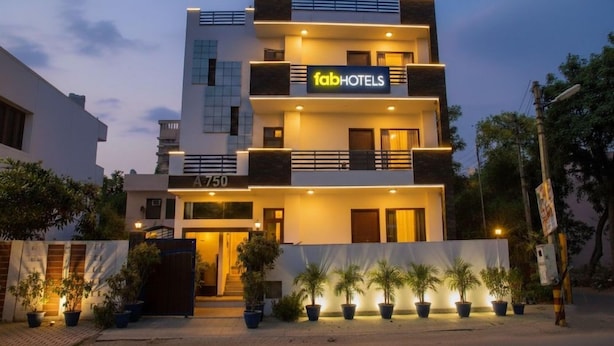 A multi-story hotel with a modern facade, a prominent 'fabHOTELS' sign, and a gated entrance. - Fabhotel The Residency DLF Galleria (Gurugram)