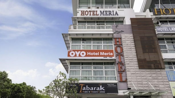 A hotel building with multiple signs including 'HOTEL MERIA' and 'OYO Hotel Meria'. - Capital O 812 Hotel SMC Seksyen 13 (Shah Alam)