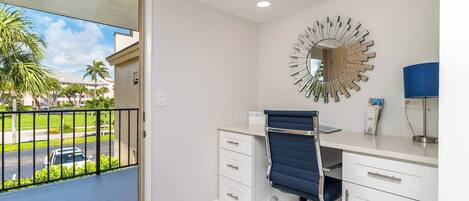 A modern office space with a desk, chair, and a decorative mirror.