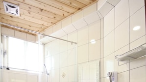A bathroom with a shower, sink, and toilet. - Q House (Puli)