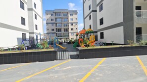A residential area with a playground, a gated entrance, and apartment buildings in the background. - 2-bedroom apartment in Nairobi near Jomo Kenyatta International airport (Nairobi)