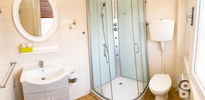 A bathroom with a glass-enclosed shower, a white sink, a toilet, and a mirror. - Hotel Villa Panda (Rimini)