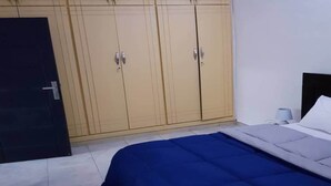 Ein Schlafzimmer mit einem Bett, einem Kleiderschrank und einem Nachttisch.