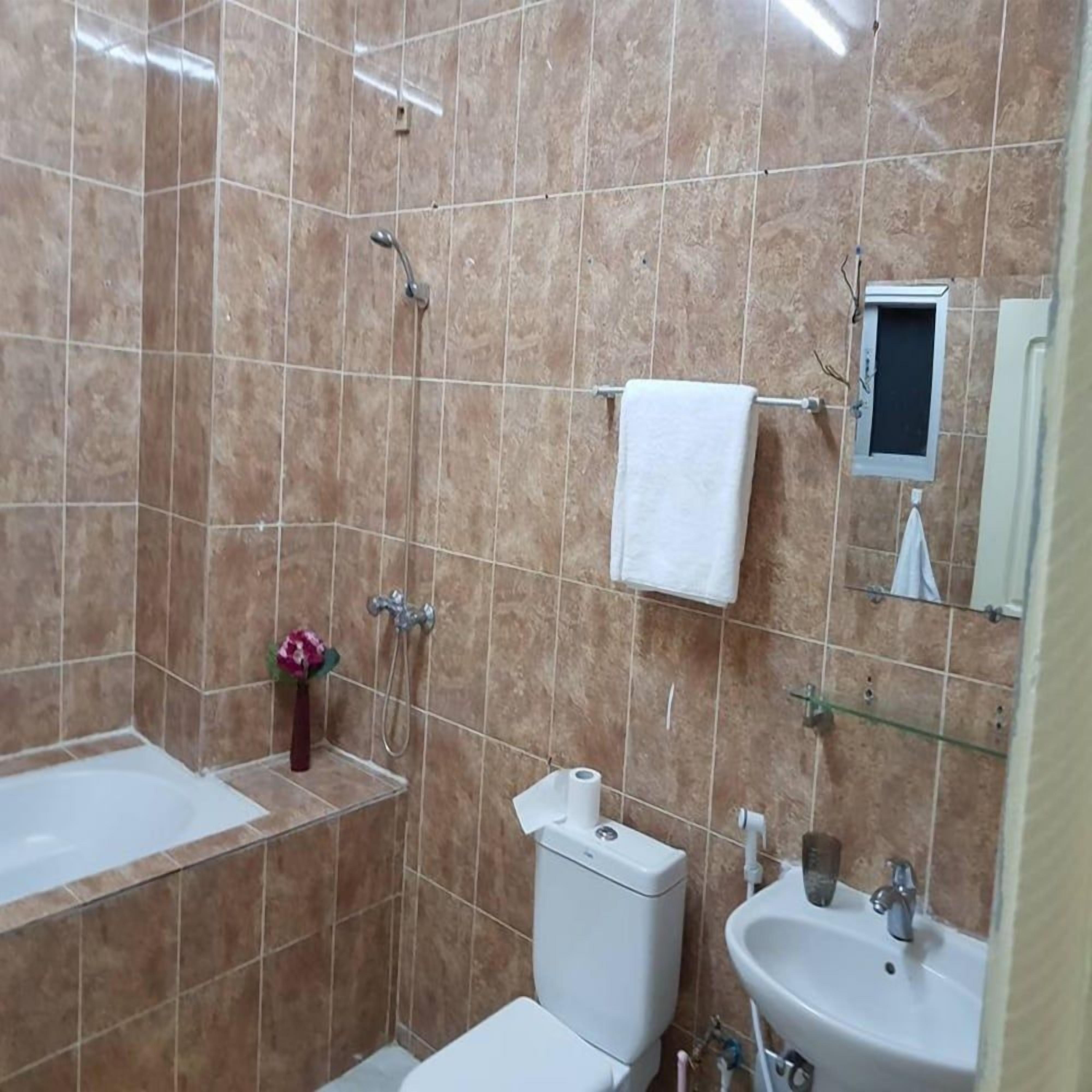 A bathroom with a bathtub, toilet, and sink, all in white.