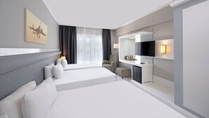 A modern hotel room with a large bed, a desk, a chair, and a TV. - Dedeman Kemer Resort (Kemer)