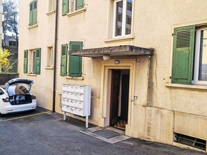 A building with a door marked '1010' and a mailbox.