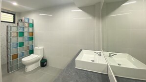 A modern bathroom with a toilet, a sink, and a mirror. - Goodview Resort & Camping (Sai Yok)