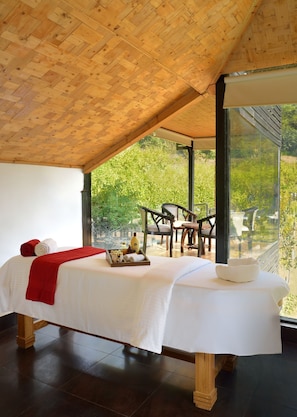A room with a wooden ceiling, a bed with white bedding, a red towel, and a tray with toiletries. - Shaantam Resorts (Yamkeshwar)
