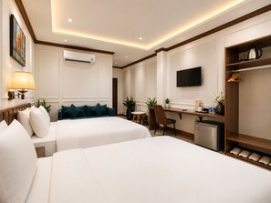 A hotel room with two beds, a desk, a TV, and a coffee machine. - KAS Ancient Boutique Hotel (Ben Thanh Ward)