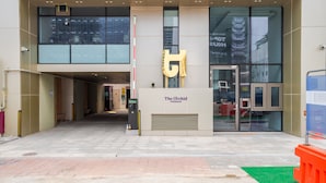 The entrance to The Orchid hotel with a large golden 'T' sign, a glass facade, and a clear view of the interior. - Orchid Cheongdam - Executive Suite - 5 mins to Coex by Taxi (Seoul)