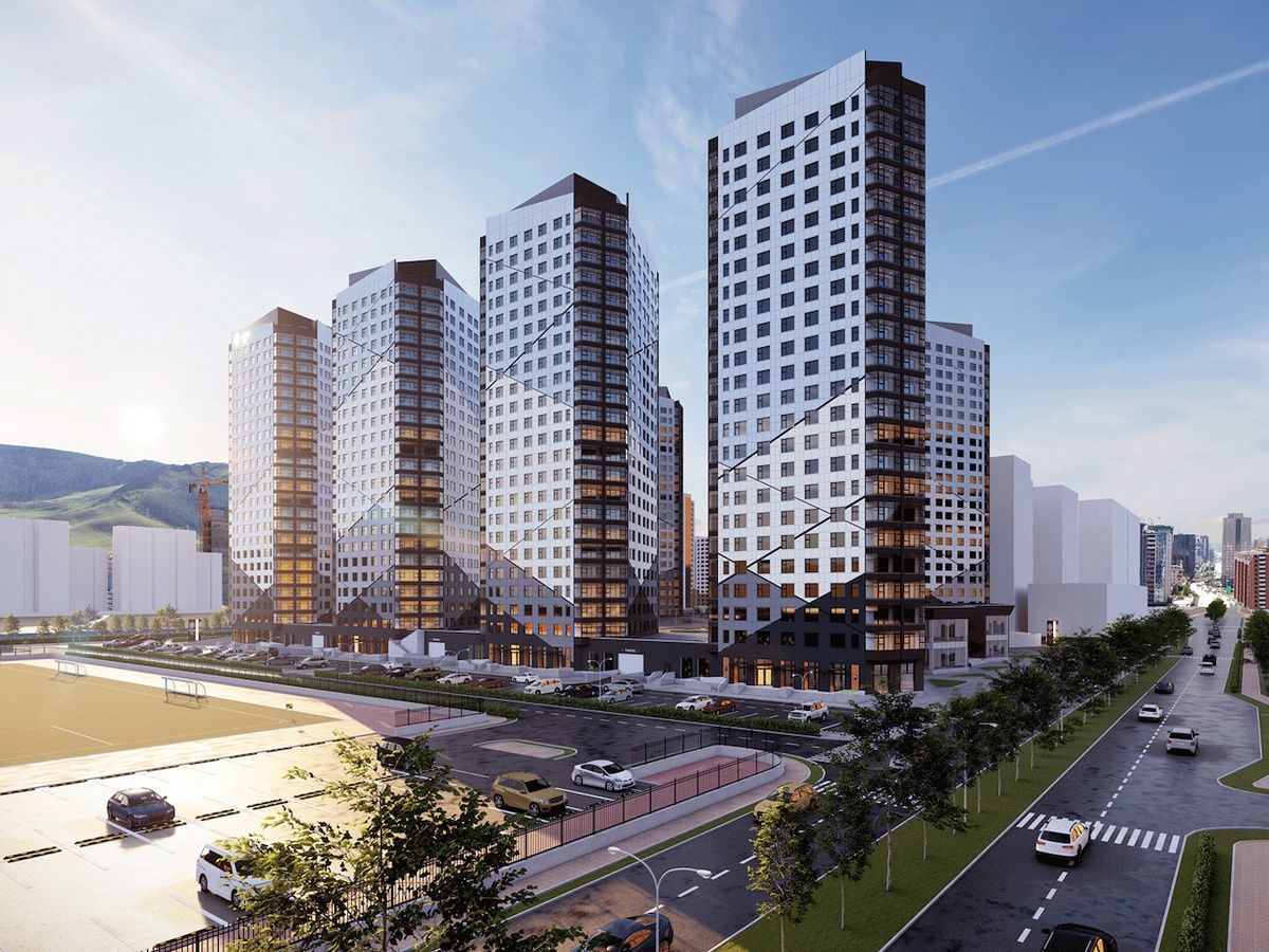 Een modern complex van hoge gebouwen met meerdere woontorens, een parkeerplaats en een weg met voertuigen.