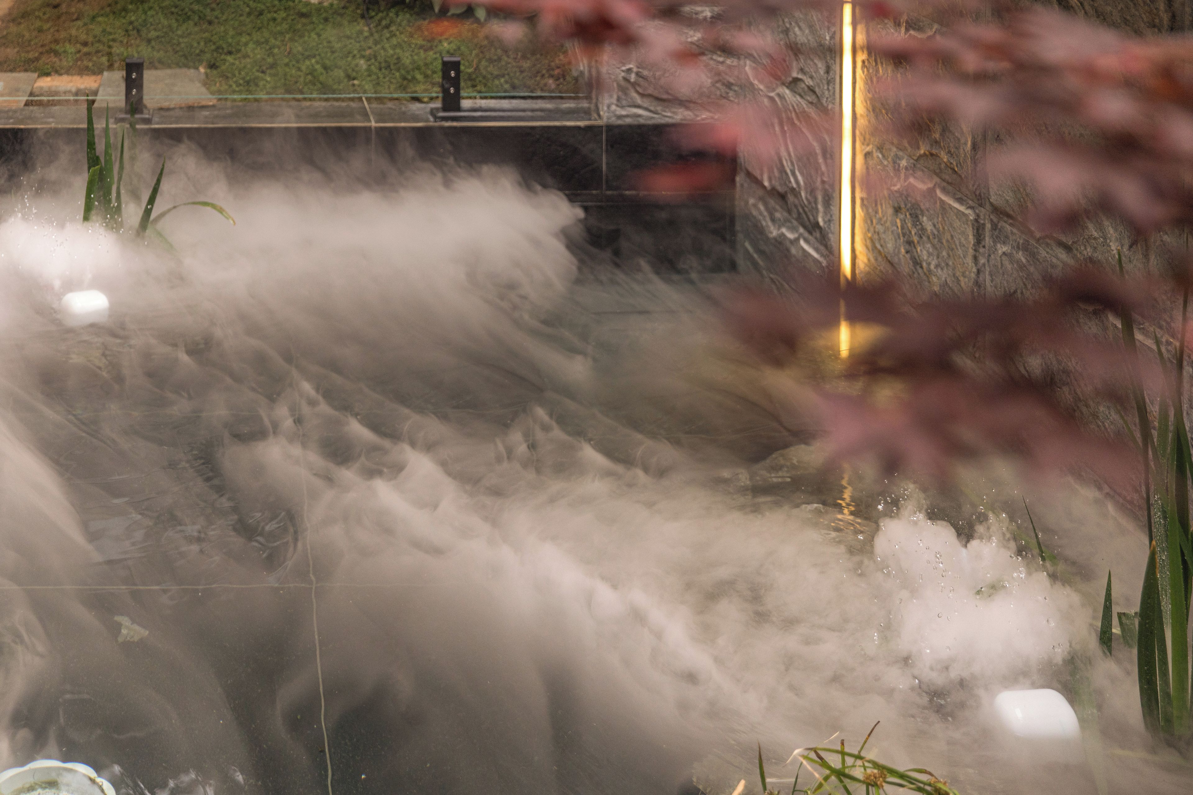 A water feature with multiple jets creating a misty effect.