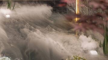 A water feature with multiple jets creating a misty effect.