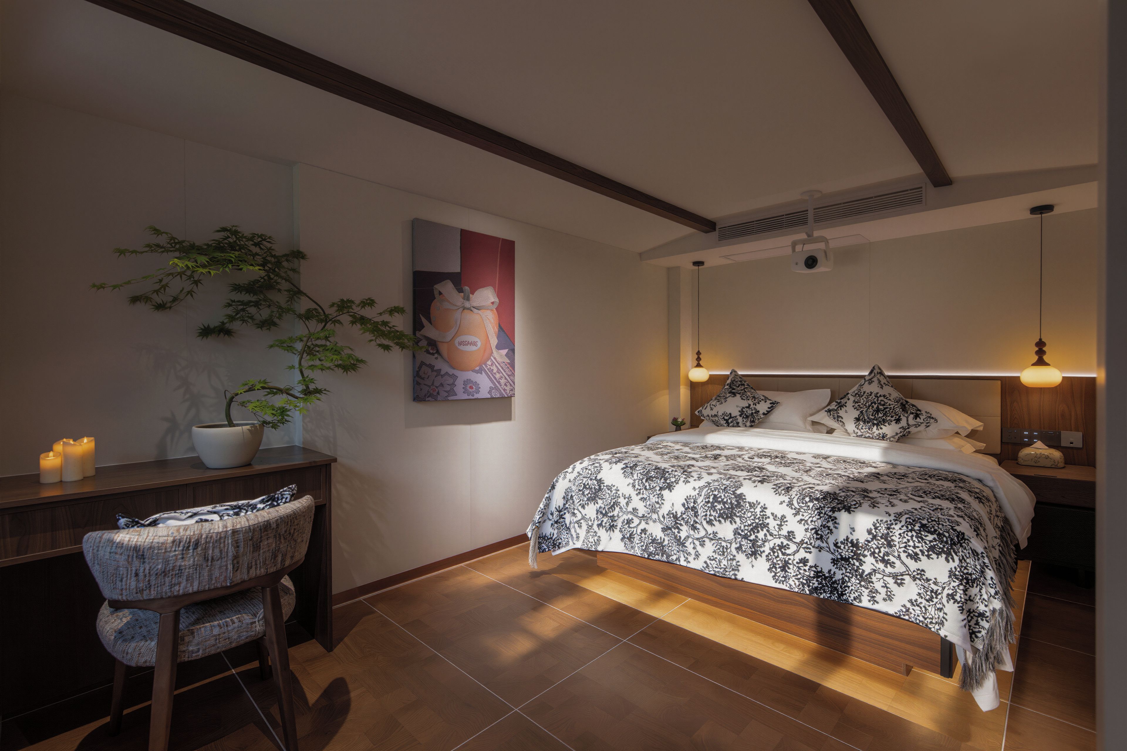 Un dormitorio con cama, mesita de noche, silla y una obra de arte colgada en la pared.