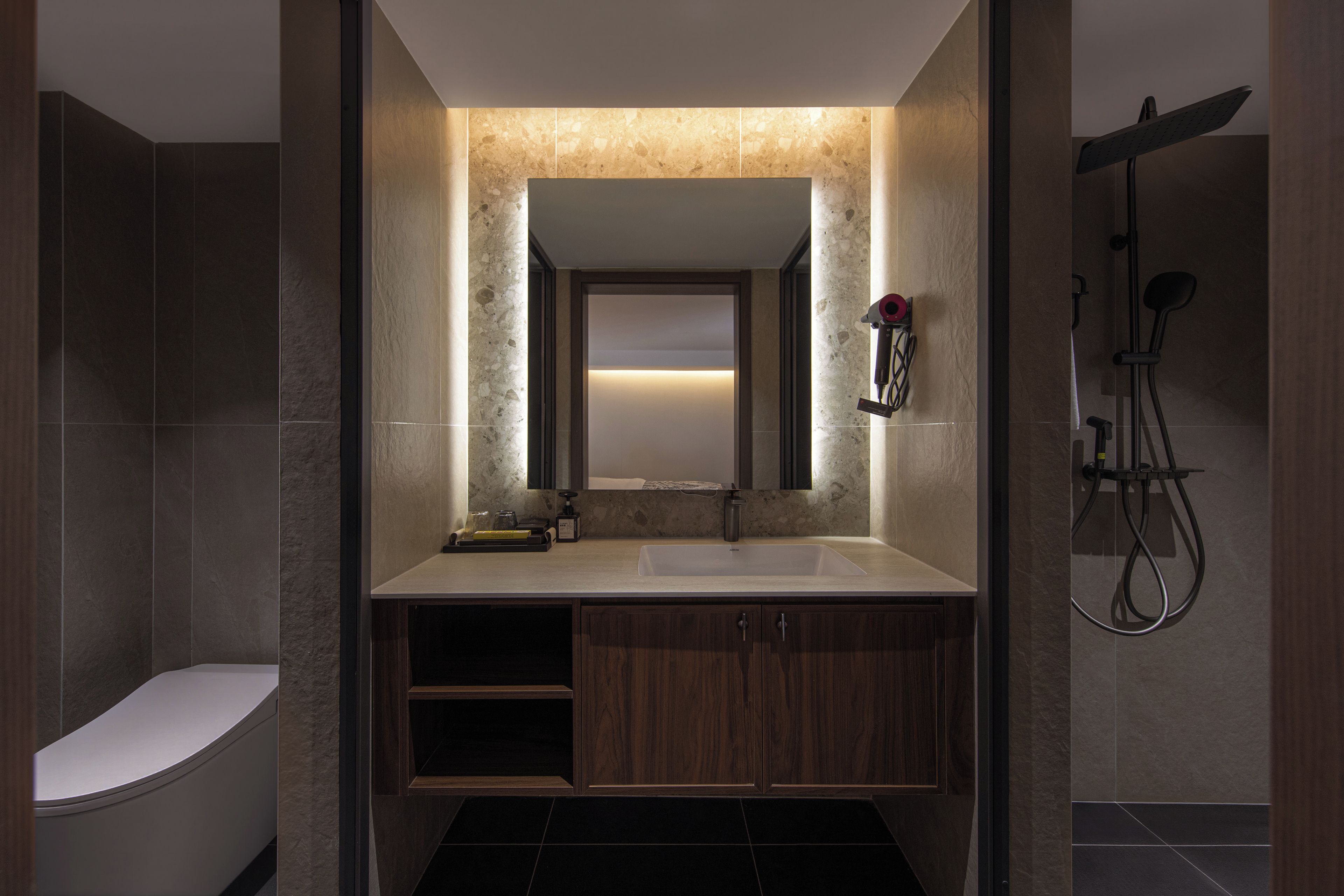 A modern bathroom with a freestanding bathtub, a vanity with a mirror, and a shower area.