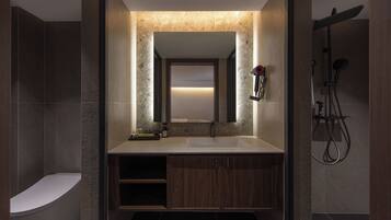 A modern bathroom with a freestanding bathtub, a vanity with a mirror, and a shower area.
