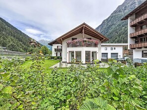 A two-story building with a balcony, surrounded by lush greenery and mountains in the background. - Chalet Jana by Interhome (Feichten im Kaunertal)