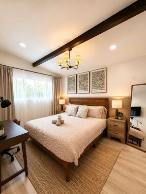 A bedroom with a large bed, bedside tables, a desk, and a mirror. - Modern & Spacious Anaheim Home 7 Min to Disneyland Game Room Theater Sleeps 14 (Anaheim)