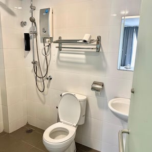 A bathroom with a toilet, bidet, and a shower with a handheld showerhead. - Hotel 57 (Subang Jaya)