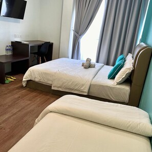 A hotel room with two beds, a desk, and a TV. - Hotel 57 (Subang Jaya)