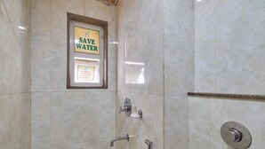 A bathroom with a framed sign that says 'SAVE WATER' and a shower with a handheld showerhead and a wall-mounted faucet. - Chas Rajdarbar Hotel & Banquets (Siliguri)