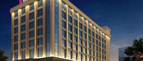 A multi-story hotel with a prominent signage at the top.