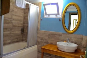 A bathroom with a shower, a sink, a mirror, and a television mounted above the sink. - Afrodit Holiday Club Altinoluk (Edremit)