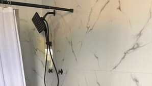 A bathroom with a shower, a toilet, and a sink. - R&R Rest & Restore (Bogwalk)