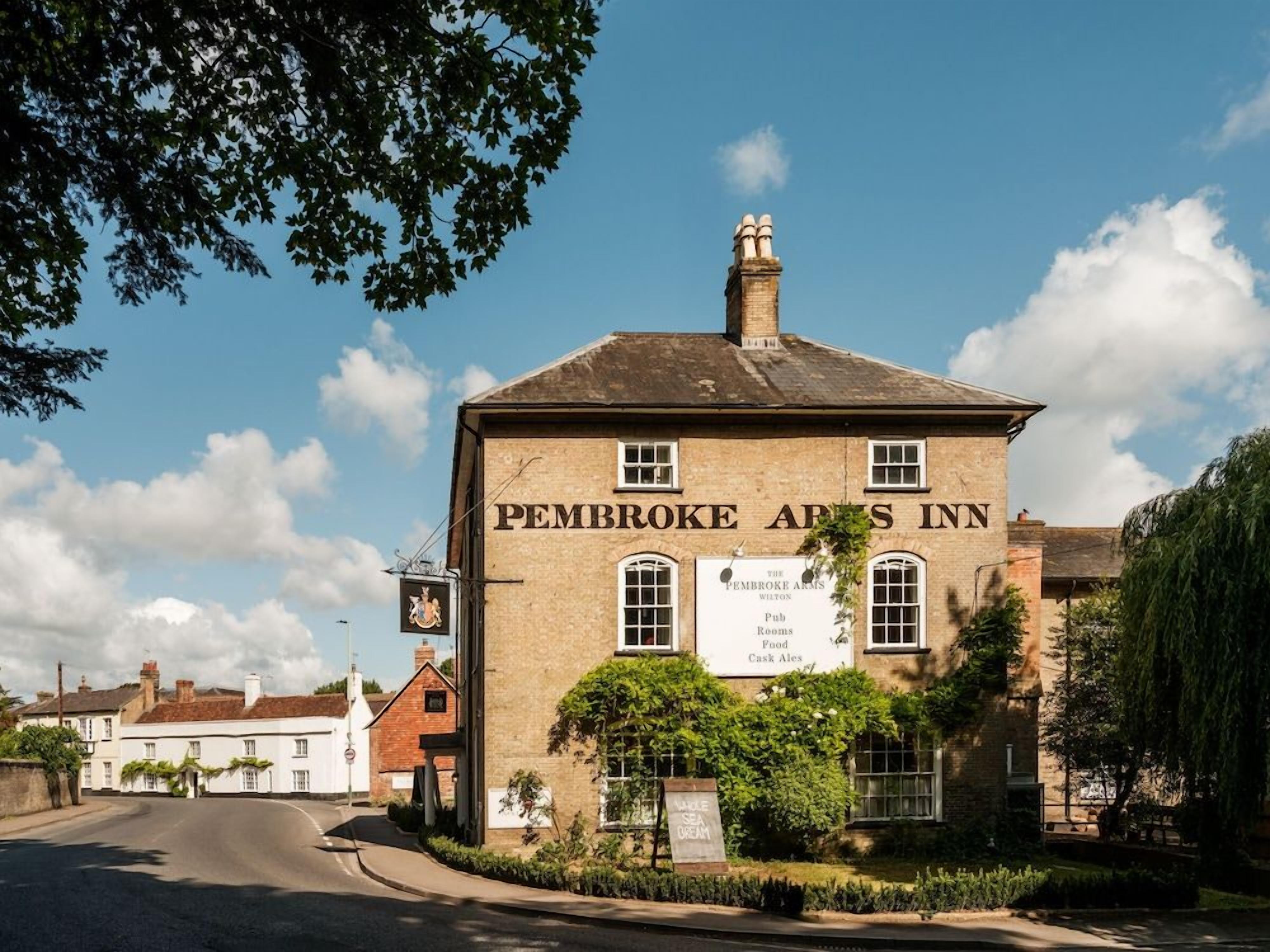 A traditional building with a sign reading 'Pembrooke Arms Inn.'
