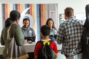 A reception area with a large number '6' on the wall, a counter, and a digital display. - 1 Queen Bed | Non-Smoking (Albuquerque)