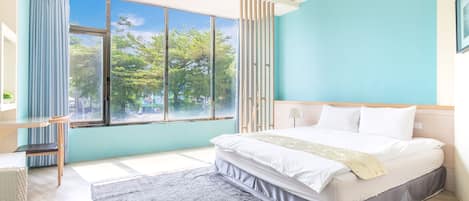 A modern bedroom with a large window, a bed, a desk, and a chair.