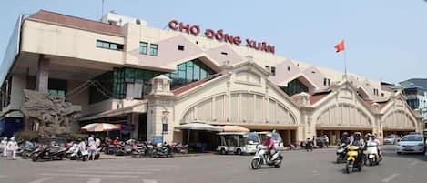 A building with the sign 'CHO DONG XUAN' and a flag on top.