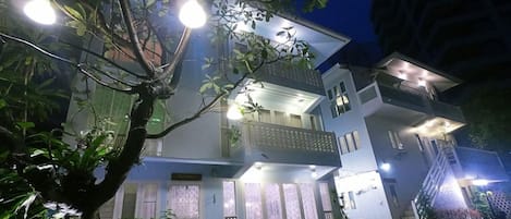 A multi-story residential building with balconies and large windows.