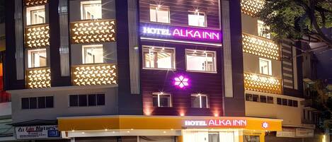 A multi-story building with a prominent 'HOTEL ALKA INN' sign.