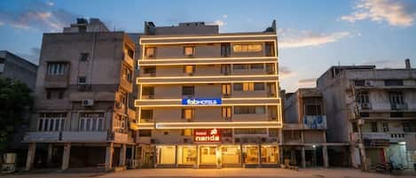 A multi-story hotel with a flat facade, a prominent 'fabHOTELS' sign, and a 'hotel nanda' sign below.